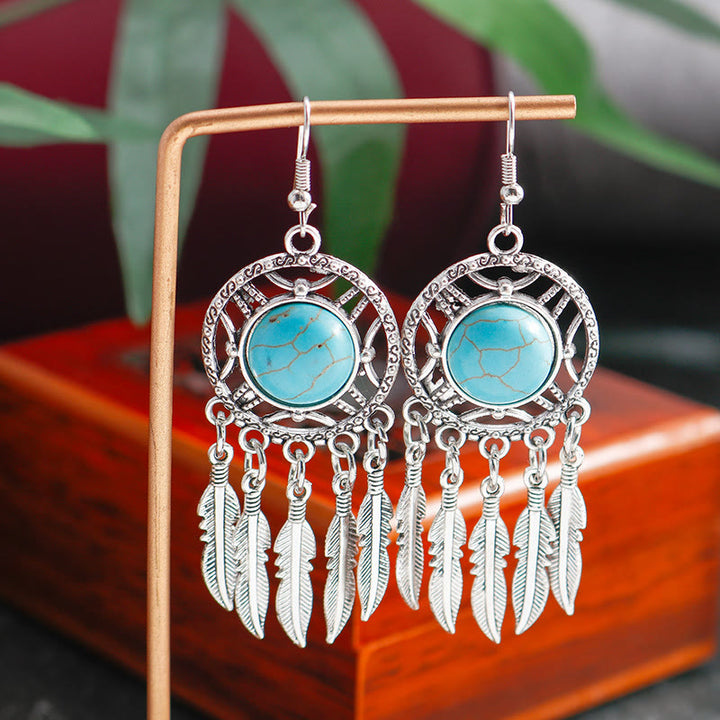 Pendientes de borlas con plumas de plata y turquesa de Olivenorma