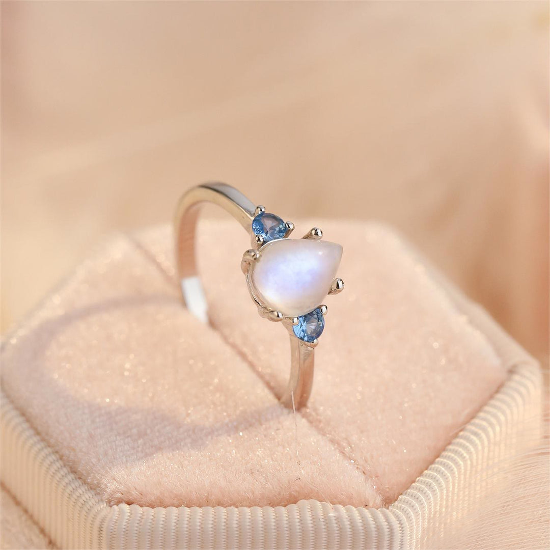 Anillo de plata de ley S925 con topacio azul y piedra lunar de Olivenorma