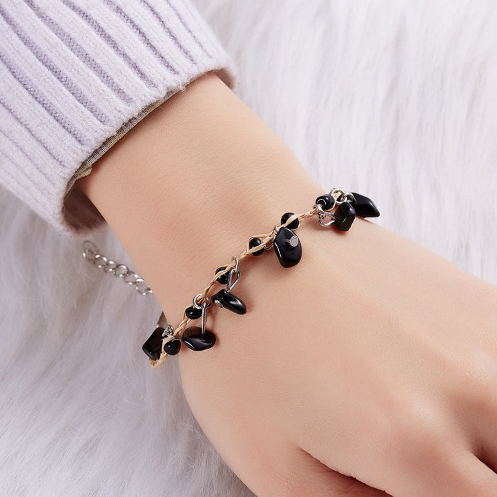 Pulsera trenzada con borlas de obsidiana, ojo de tigre y amatista de Olivenorma
