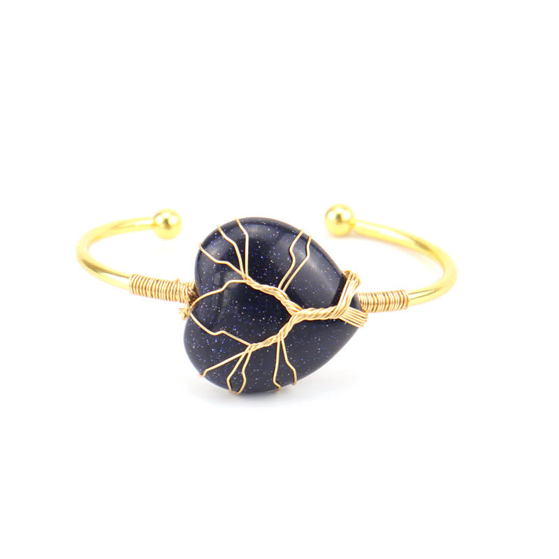 Pulsera de cristal natural en forma de corazón envuelta en alambre de cobre y oro de Olivenorma.