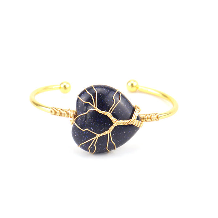 Pulsera de cristal natural en forma de corazón envuelta en alambre de cobre y oro de Olivenorma.