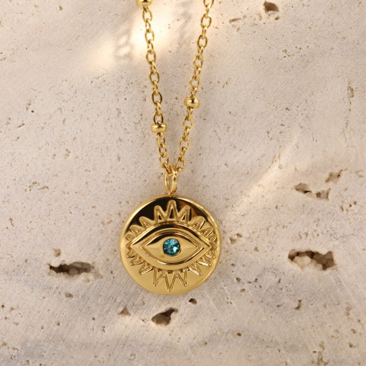 Collar de acero de titanio 316L con ojo malvado y topacio azul de Olivenorma