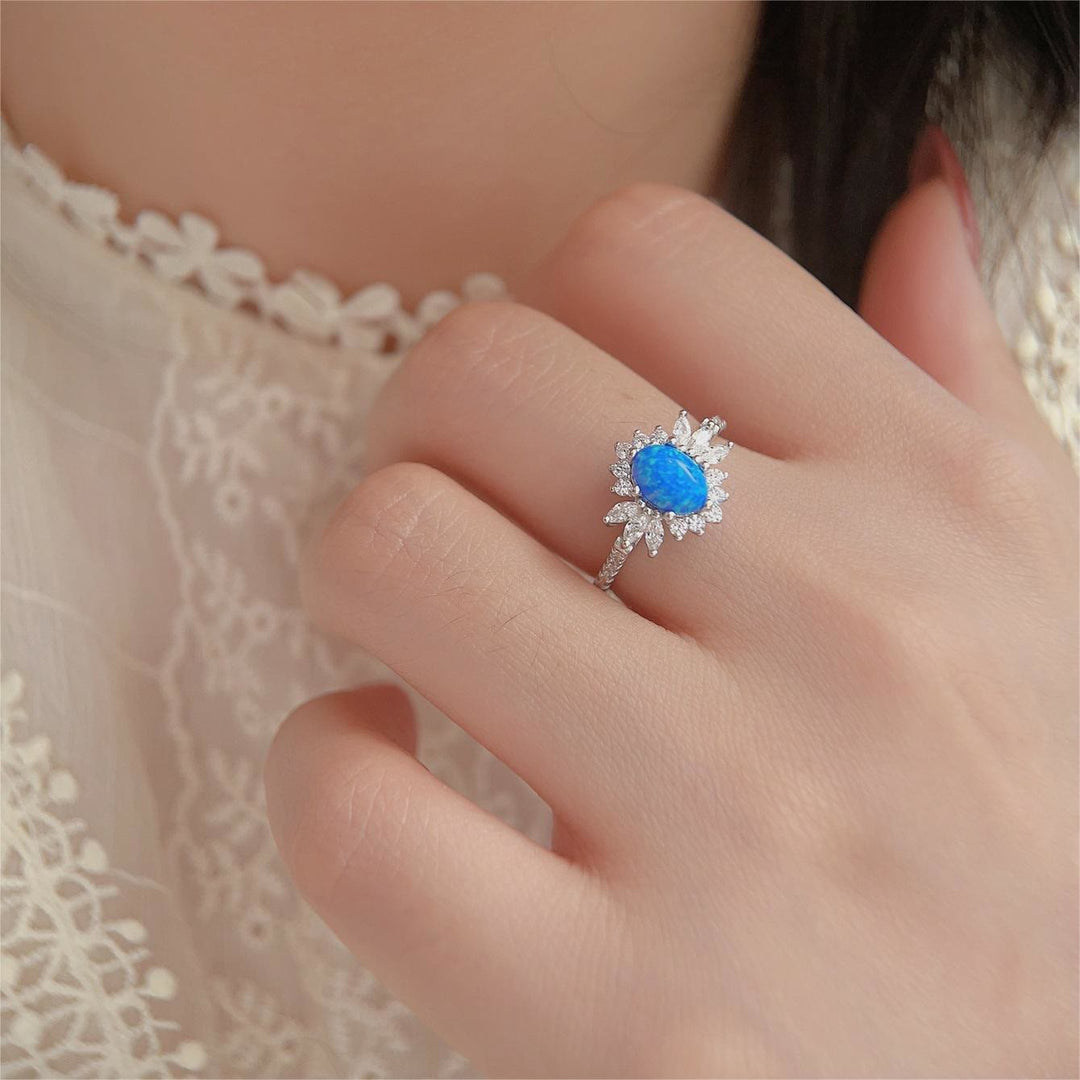 Anillo de plata 925 con diseño de girasol y ópalo azul blanco de Olivenorma 