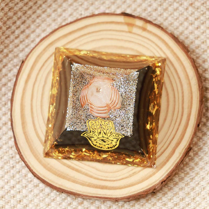 Pirámide de orgón de hamsa de obsidiana y cristal transparente de Olivenorma 