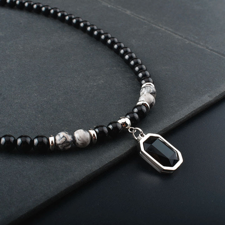 Collar de acero y titanio con cuentas de obsidiana y ojo de tigre para hombre de Olivenorma