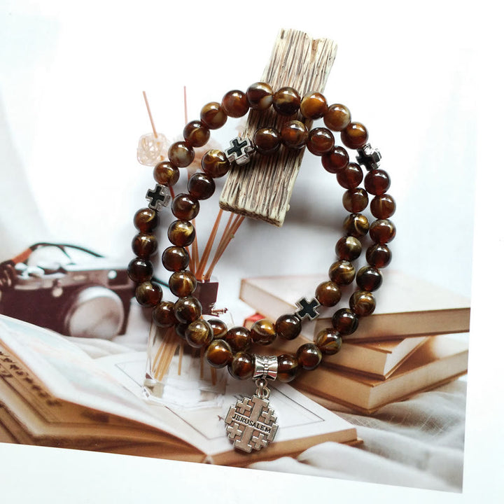 Pulsera rosario con colgante de cruz de ojo de tigre de Olivenorma