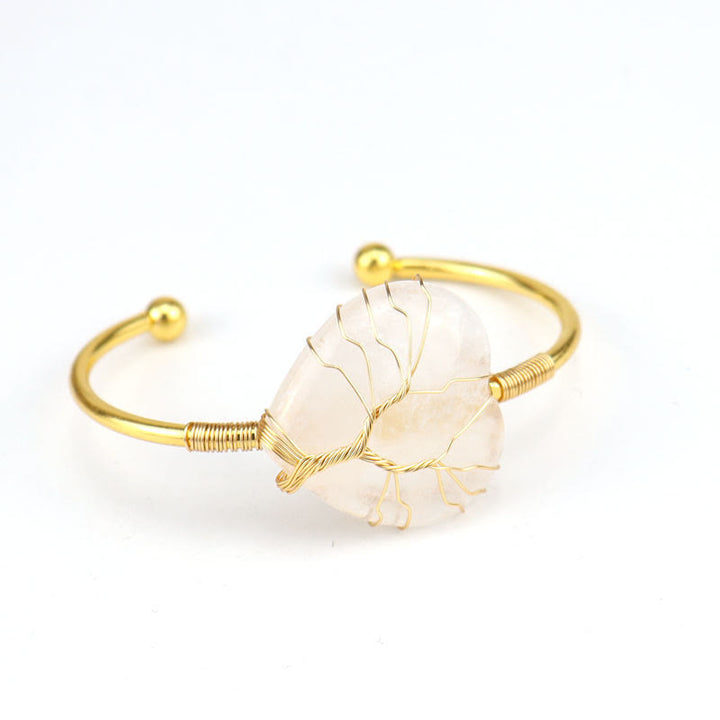 Pulsera de cristal natural en forma de corazón envuelta en alambre de cobre y oro de Olivenorma.