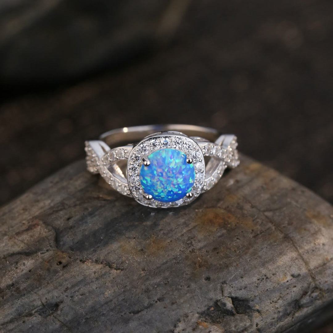 Anillo de plata de ley 925 con circonita blanca y ópalo azul de Olivenorma