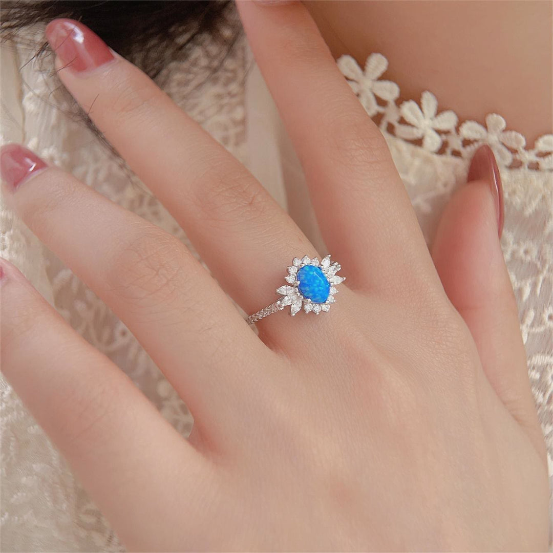 Anillo de plata 925 con diseño de girasol y ópalo azul blanco de Olivenorma 