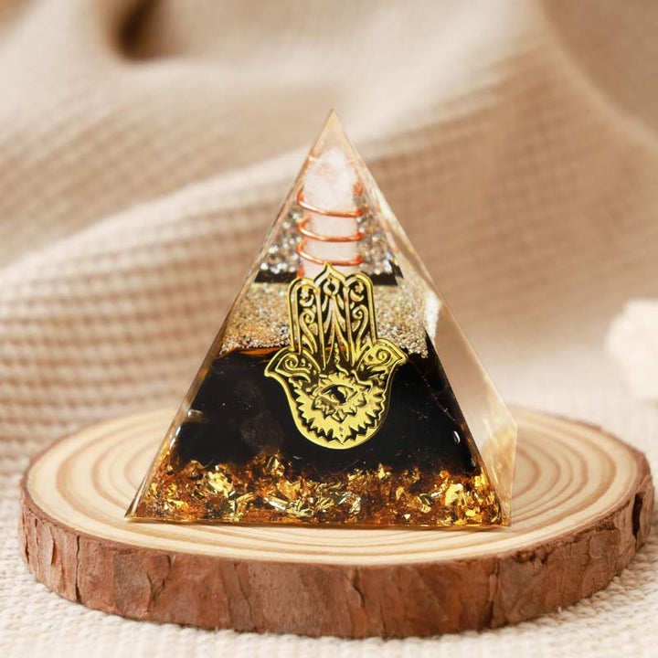 Pirámide de orgón de hamsa de obsidiana y cristal transparente de Olivenorma 