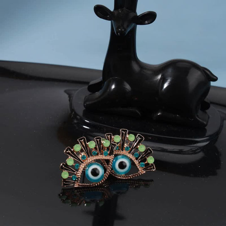 Pendientes creativos de pavo real con zafiro "Ojo de la perdición" de Olivenorma