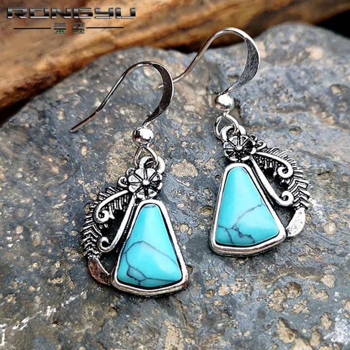 Pendientes de plumas talladas en plata y turquesa blanca de Olivenorma