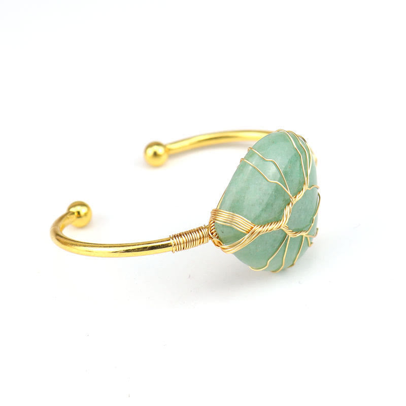 Pulsera de cristal natural en forma de corazón envuelta en alambre de cobre y oro de Olivenorma.