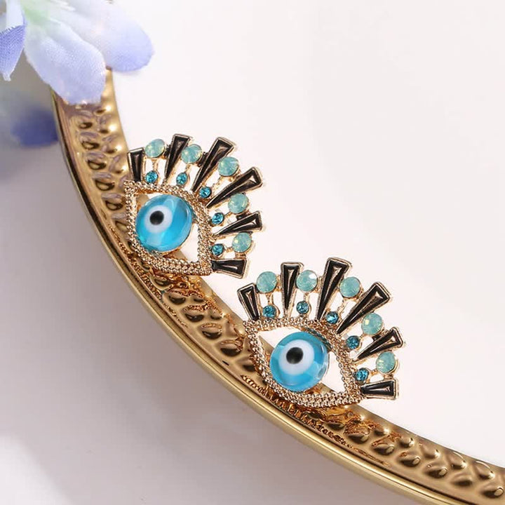 Pendientes creativos de pavo real con zafiro "Ojo de la perdición" de Olivenorma
