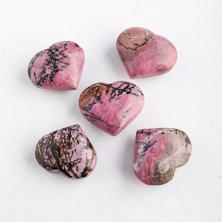 Piedra de juego pulida de rodonita de Olivenorma con forma de corazón de cristal