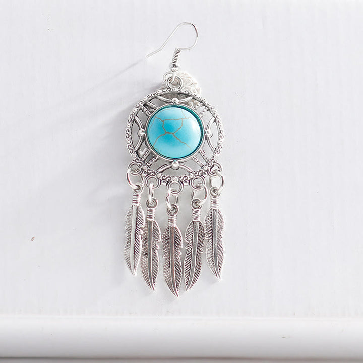 Pendientes de borlas con plumas de plata y turquesa de Olivenorma