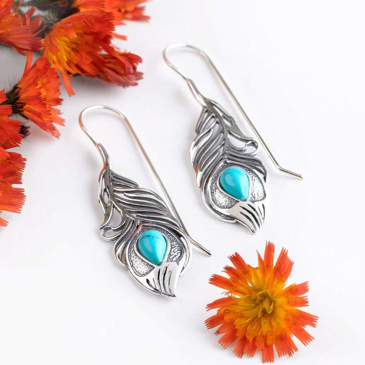 Pendientes bohemios con plumas de pavo real turquesas recortadas de Olivenorma