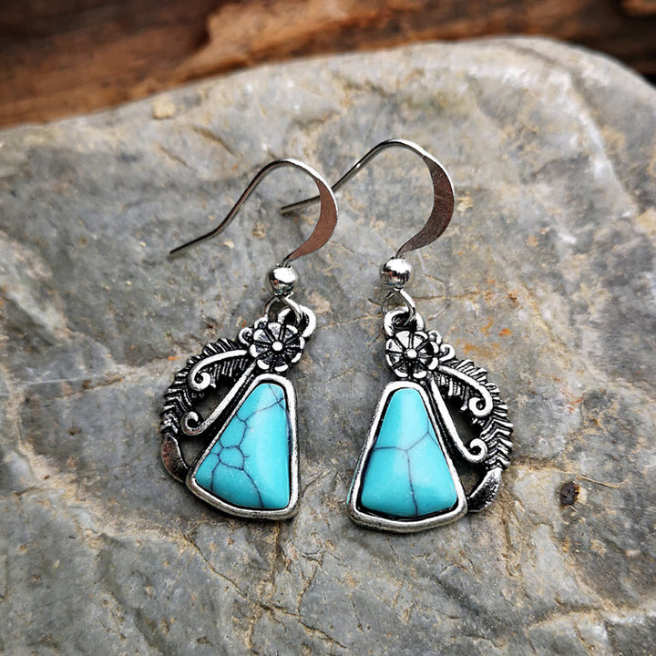 Pendientes de plumas talladas en plata y turquesa blanca de Olivenorma