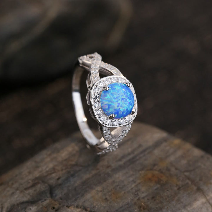 Anillo de plata de ley 925 con circonita blanca y ópalo azul de Olivenorma