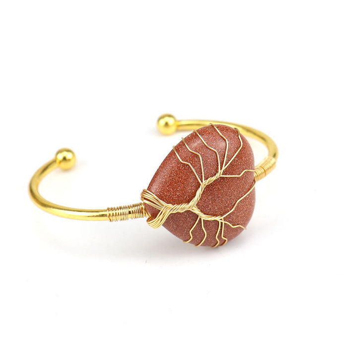 Pulsera de cristal natural en forma de corazón envuelta en alambre de cobre y oro de Olivenorma.