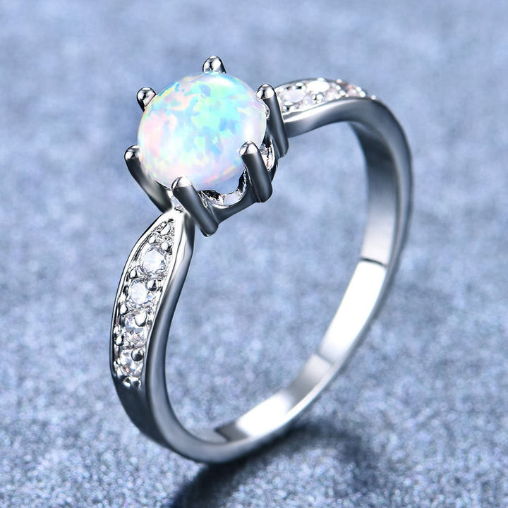 Anillo de banda con borde de ópalo redondo y seis garras de Olivenorma