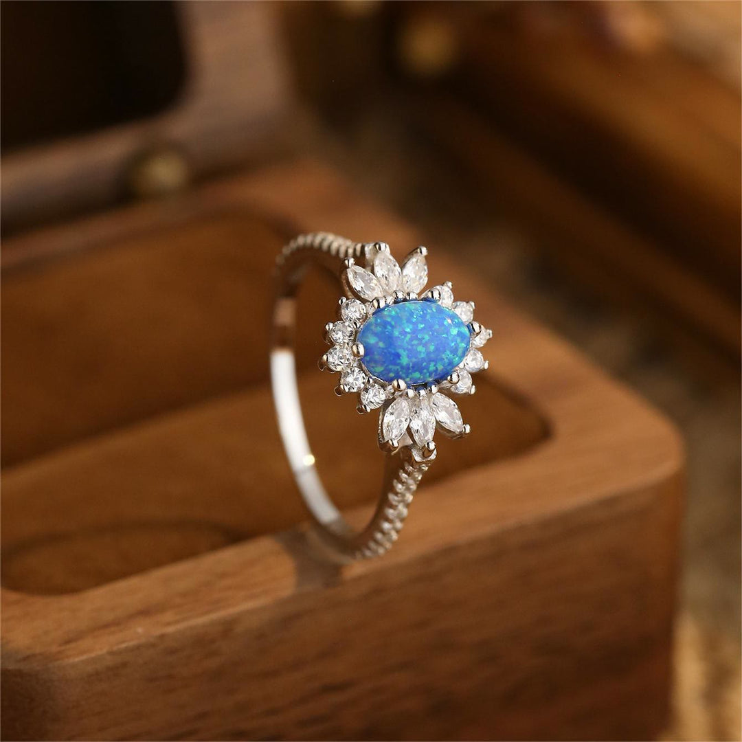 Anillo de plata 925 con diseño de girasol y ópalo azul blanco de Olivenorma 