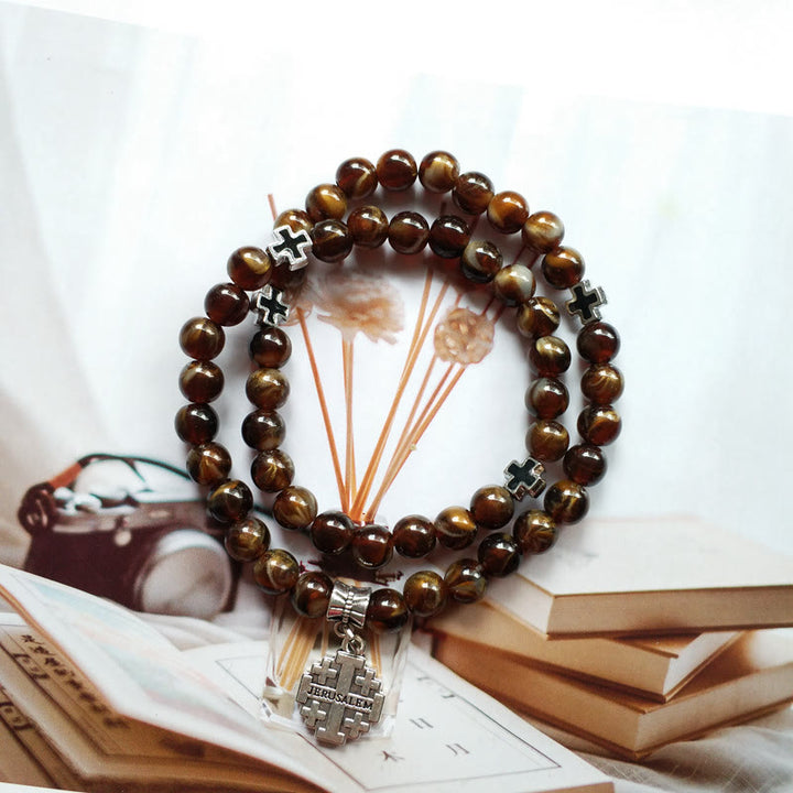 Pulsera rosario con colgante de cruz de ojo de tigre de Olivenorma