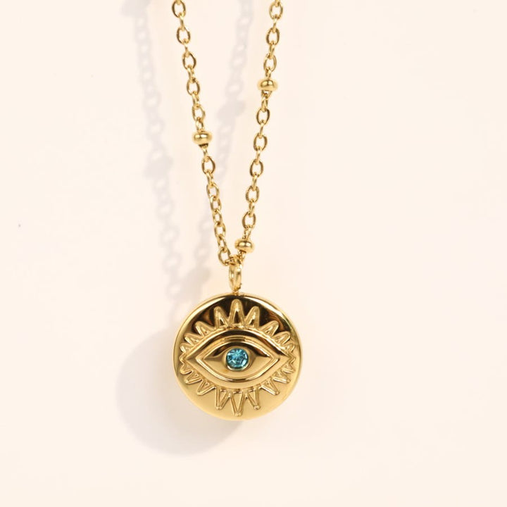 Collar de acero de titanio 316L con ojo malvado y topacio azul de Olivenorma