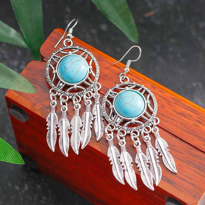 Pendientes de borlas con plumas de plata y turquesa de Olivenorma