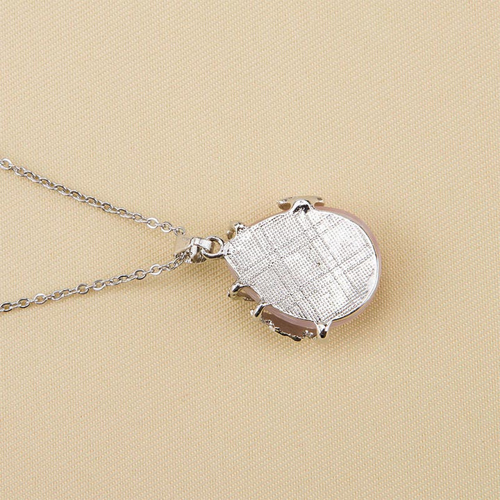 Collar de piedras preciosas con alas de mariposa de cristal.