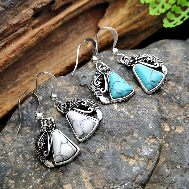 Pendientes de plumas talladas en plata y turquesa blanca de Olivenorma