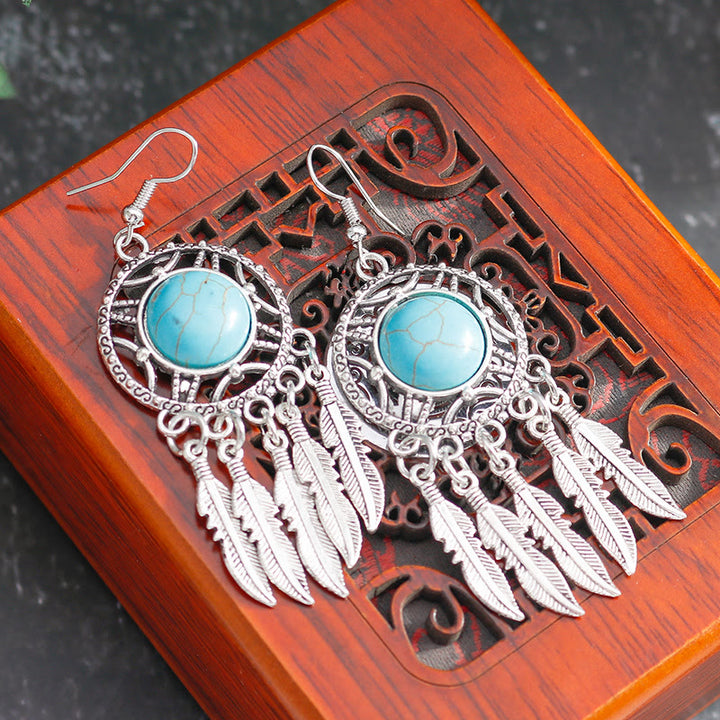 Pendientes de borlas con plumas de plata y turquesa de Olivenorma
