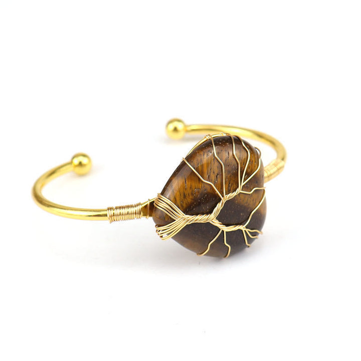 Pulsera de cristal natural en forma de corazón envuelta en alambre de cobre y oro de Olivenorma.