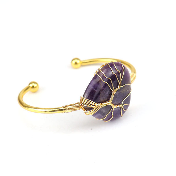 Pulsera de cristal natural en forma de corazón envuelta en alambre de cobre y oro de Olivenorma.