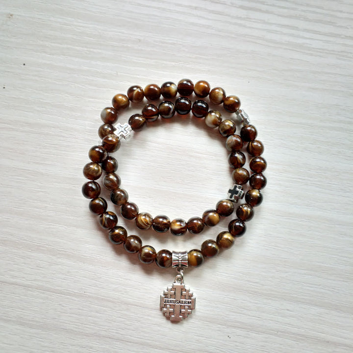 Pulsera rosario con colgante de cruz de ojo de tigre de Olivenorma