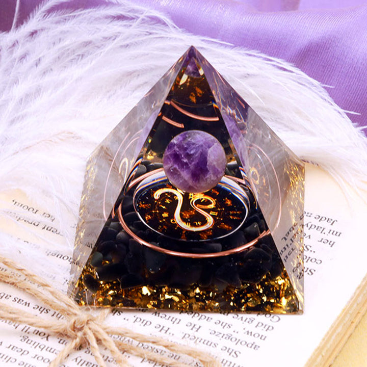 Pirámide de orgón del zodiaco Leo con esfera de amatista y obsidiana de Olivenorma 