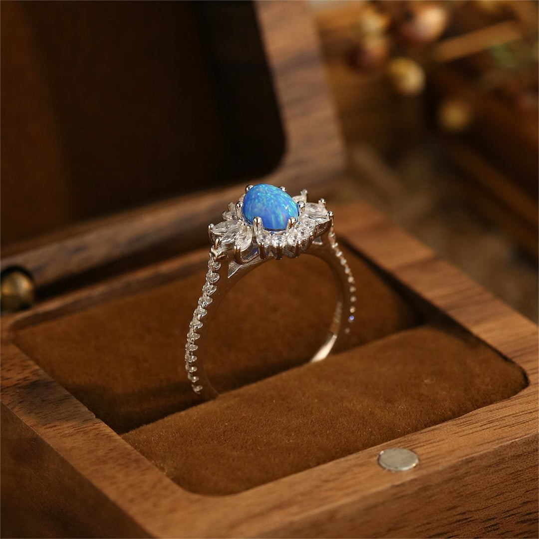Anillo de plata 925 con diseño de girasol y ópalo azul blanco de Olivenorma 