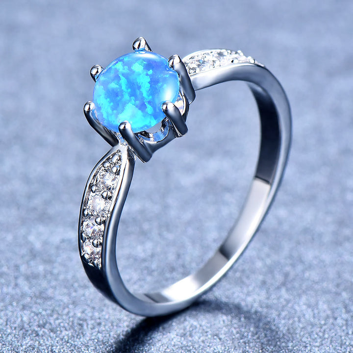 Anillo de banda con borde de ópalo redondo y seis garras de Olivenorma