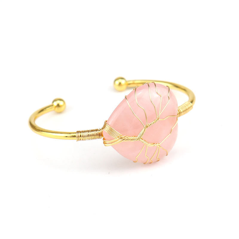 Pulsera de cristal natural en forma de corazón envuelta en alambre de cobre y oro de Olivenorma.