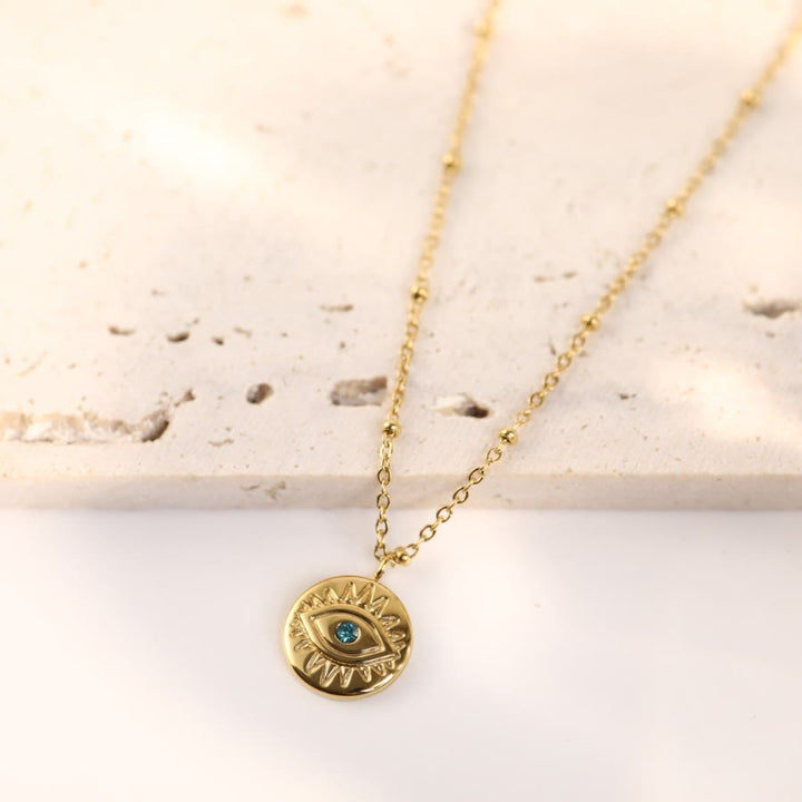 Collar de acero de titanio 316L con ojo malvado y topacio azul de Olivenorma