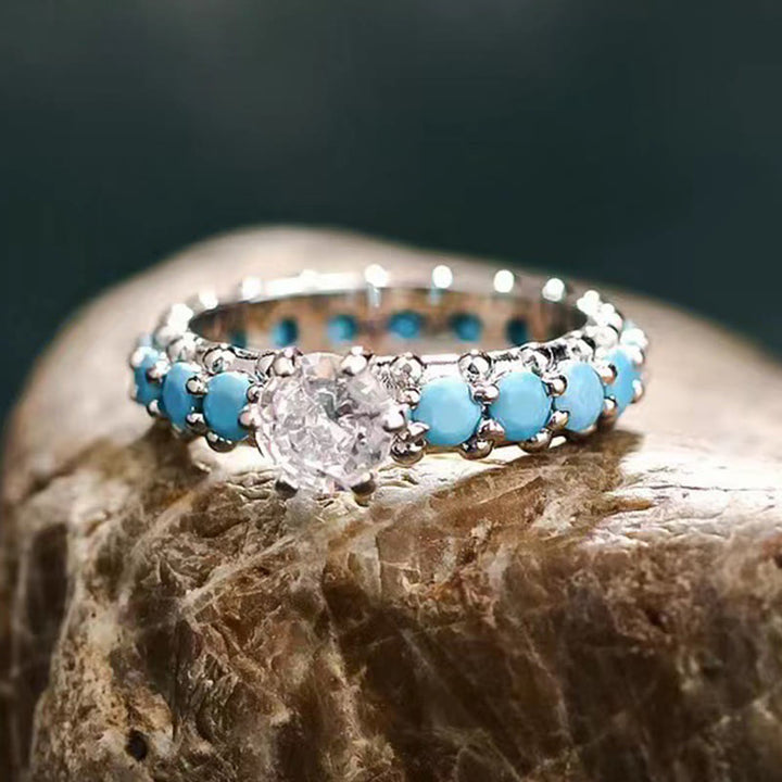 Anillo de compromiso con diamantes y circonita blanca turquesa de Olivenorma