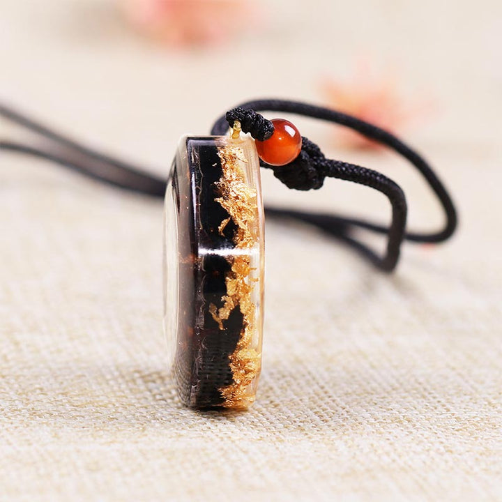 Collar con símbolo del cubo de Metatrón en obsidiana y granate de Olivenorma 