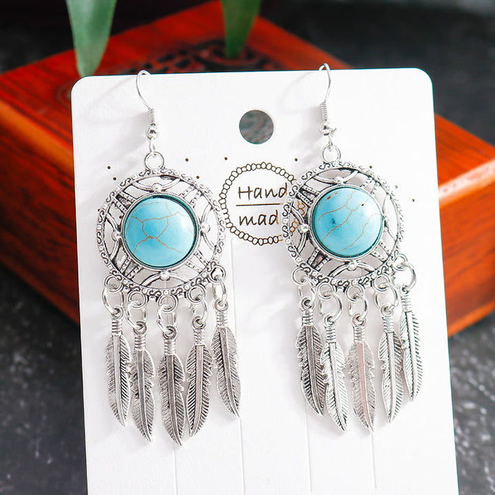 Pendientes de borlas con plumas de plata y turquesa de Olivenorma