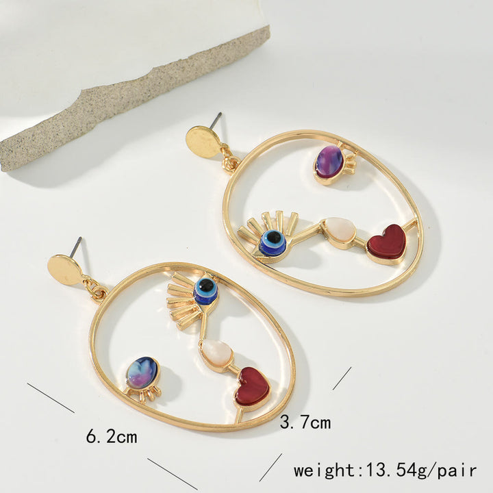 Pendientes con colgante de cara de mal de ojo de ágata roja de Olivenorma