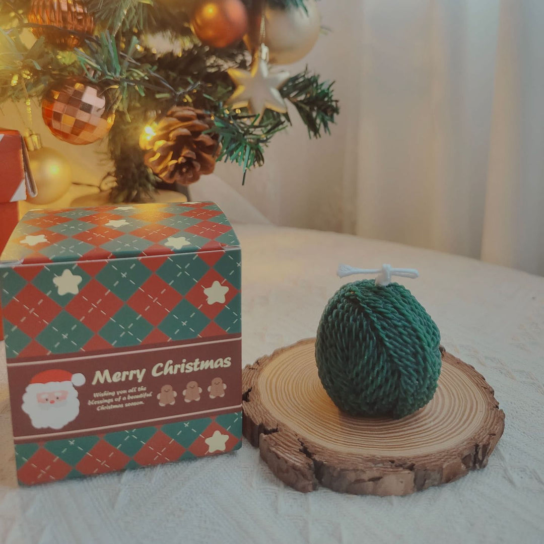 Vela con forma de calcetín navideño hecha con ovillo de lana y guante grabado de Olivenorma 
