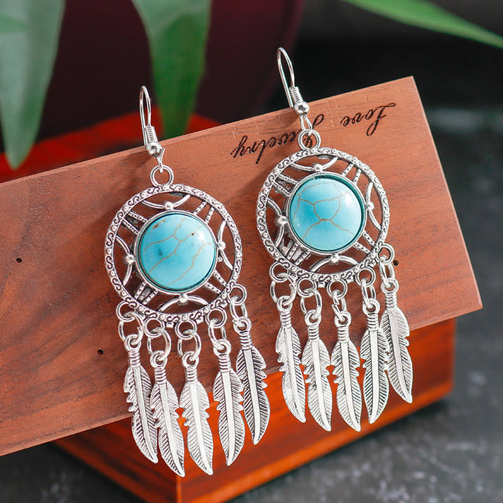 Pendientes de borlas con plumas de plata y turquesa de Olivenorma