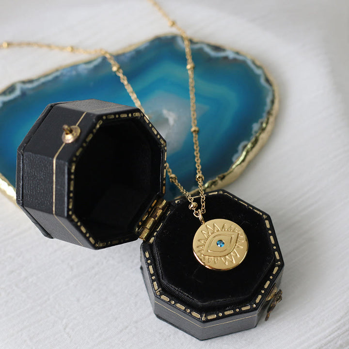 Collar de acero de titanio 316L con ojo malvado y topacio azul de Olivenorma