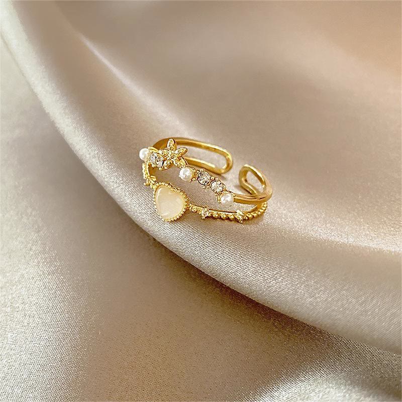 Anillo ajustable con piedra de ojo de gato y circonita blanca de Olivenorma 