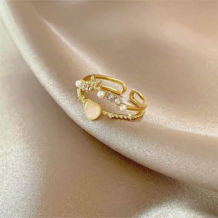 Anillo ajustable con piedra de ojo de gato y circonita blanca de Olivenorma 