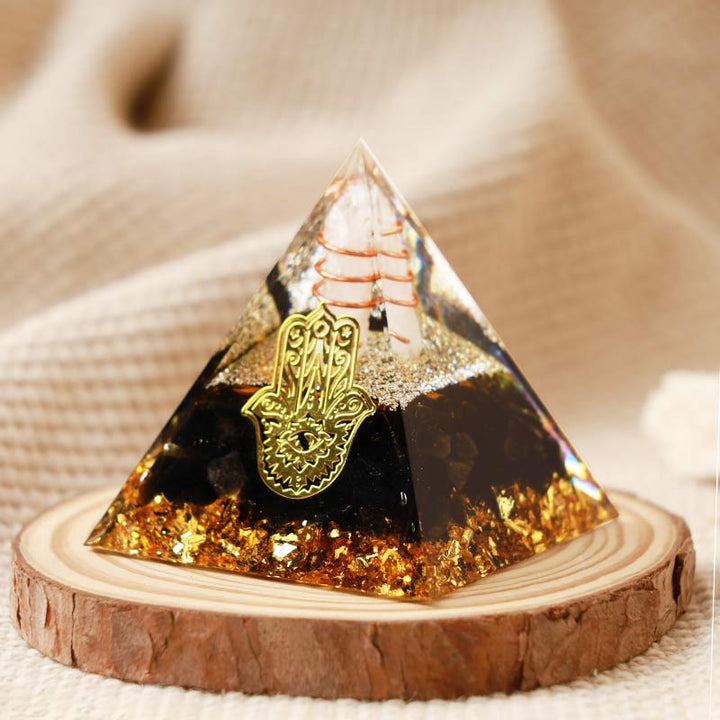 Pirámide de orgón de hamsa de obsidiana y cristal transparente de Olivenorma 